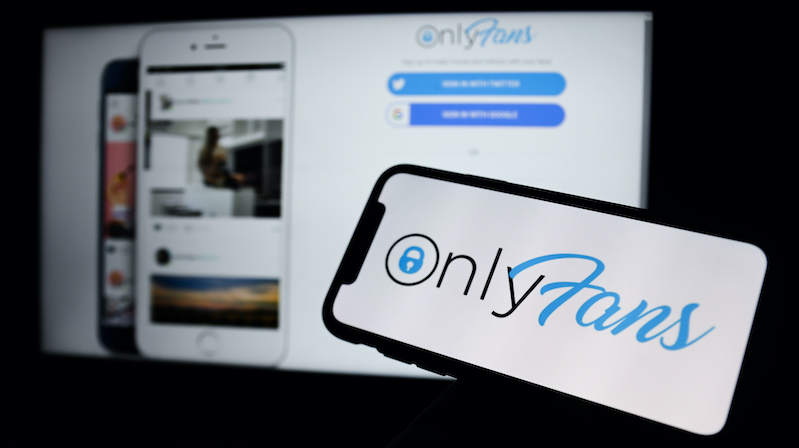 Website and smartphone showing OnlyFans logo