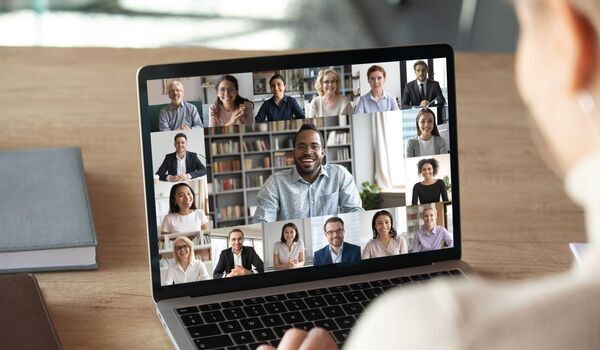 A laptop screen with a virtual meeting taking place