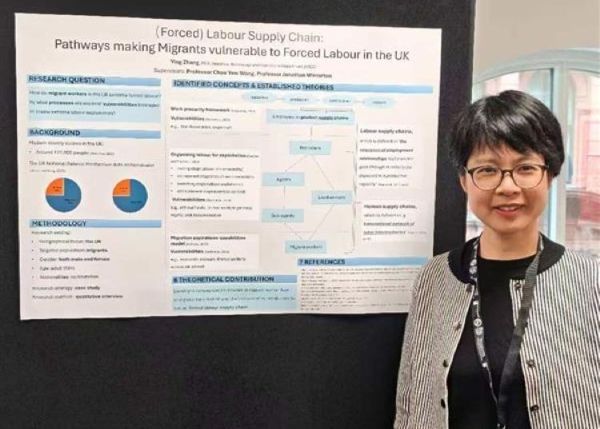 Ying stood in front of her research poster