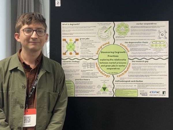 Luke stood in front of his research poster