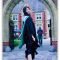 graduation image of Mia in front of arch walkway
