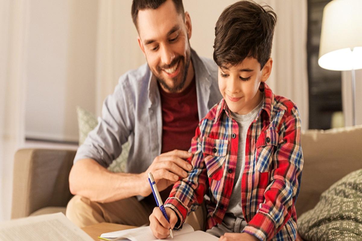 A father is show helping his son with homework.