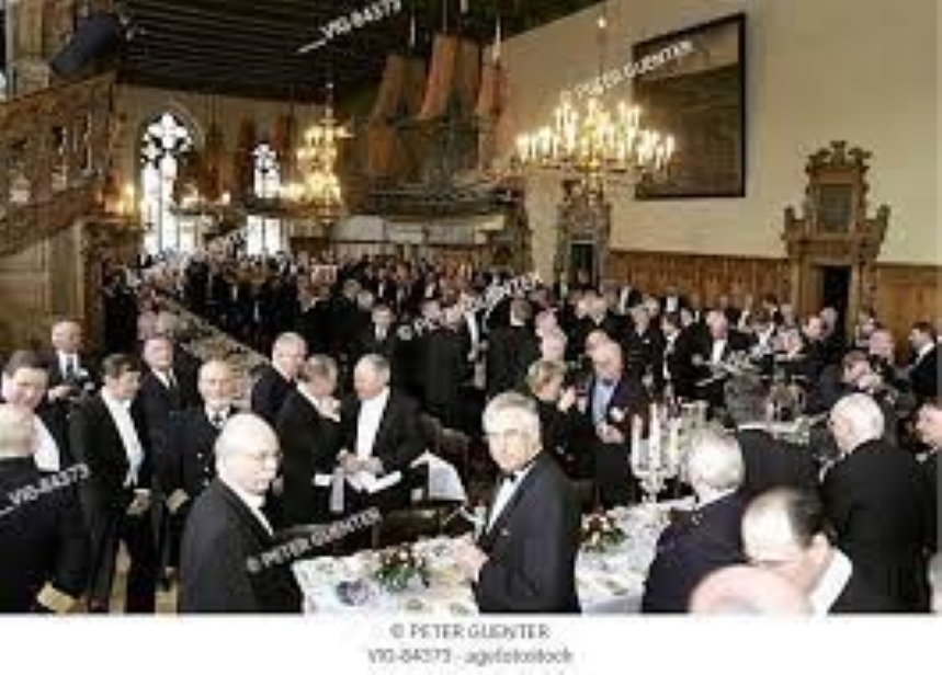 Picture shows the Schaffermahl: An all men gathering of merchants ship owners and captains dressed formal black tie dinner suits celebrating over a traditional meal and drinks