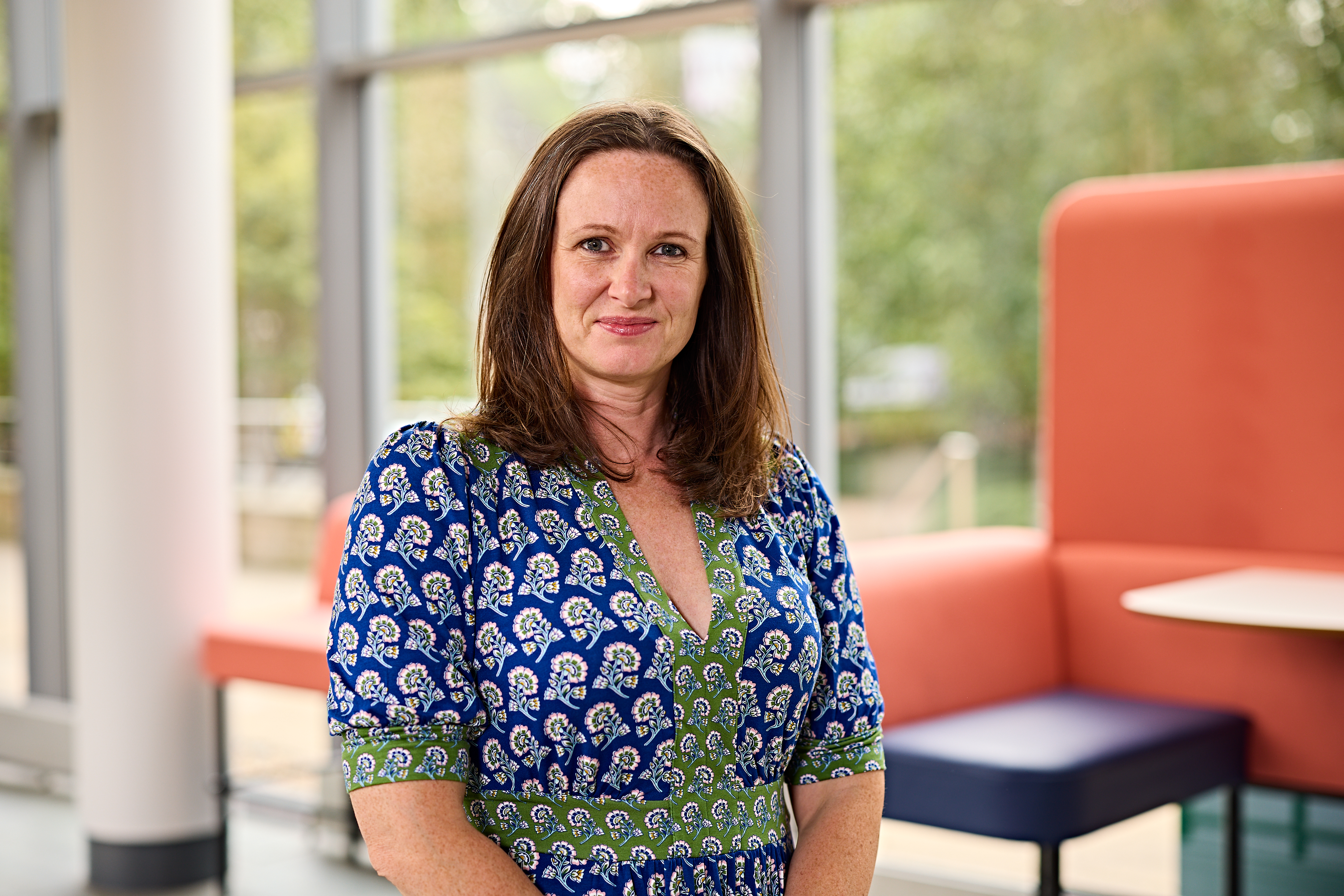 Prof Jennifer Tomlinson faces the camera in a blue blouse