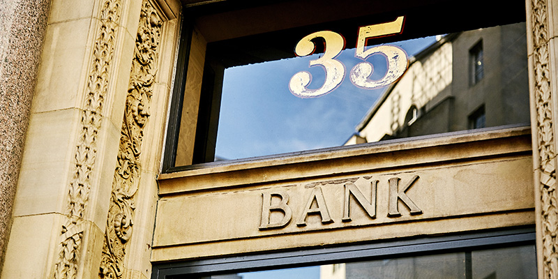 A close up of the door to a bank