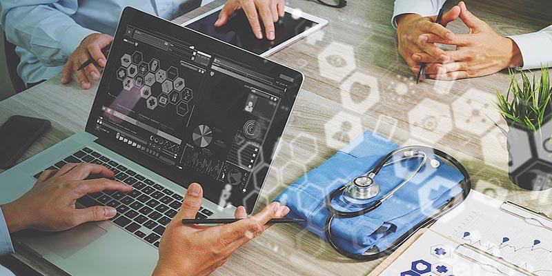 Doctors working on a laptop