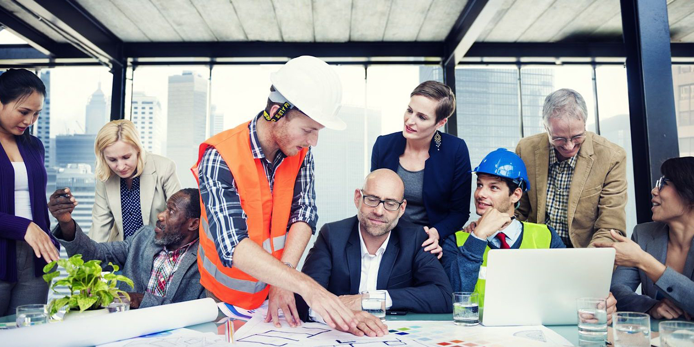 An engineer speaks to a group of office workers