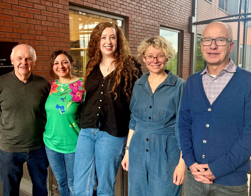 John Palfreyman, Sanaz Sigaroudi, Deirdre Coveney, Lena Jaspersen and Tony Morgan, stood in a line together, smiling at the camera