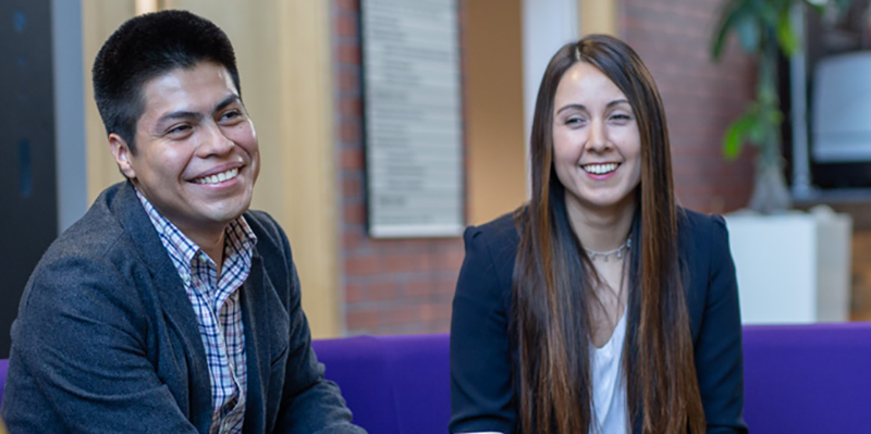 PhD male and female students smiling