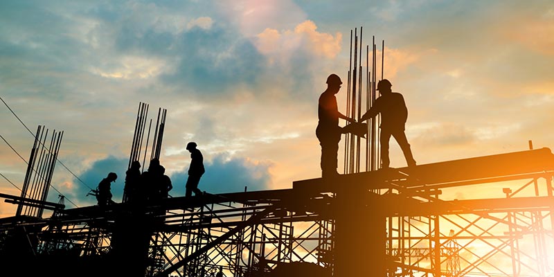 Building contractors working on a steel frame