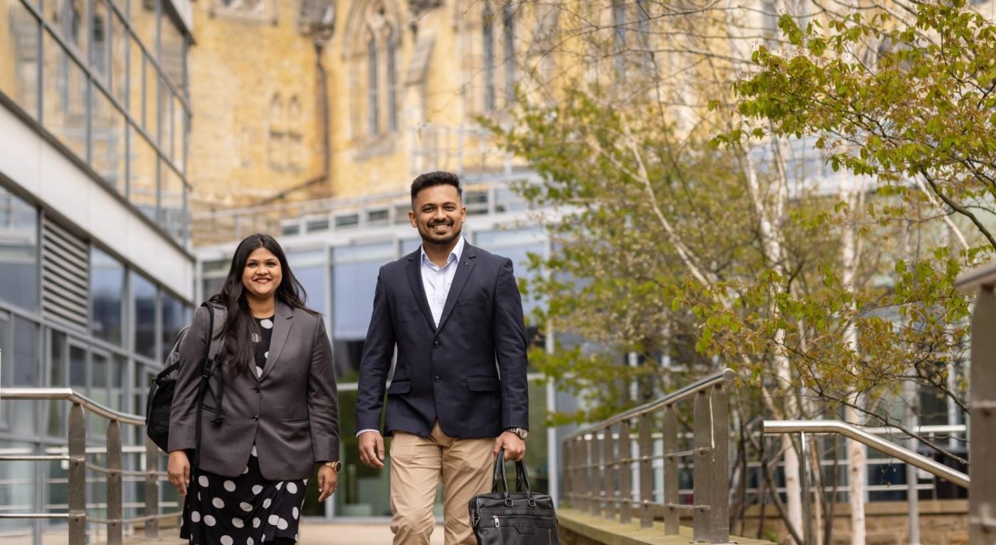 Two MBA students walking away from the Maurice Keyworth building.