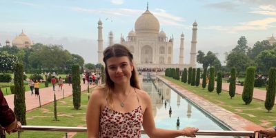 photo of Beth Waas stood outside the Taj Mahal in India.
