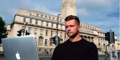 Photograph of Student George Biddie in front of Parkinson Building