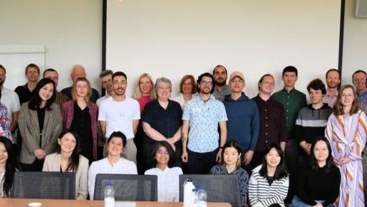 A group of people stood together, posing for the photo