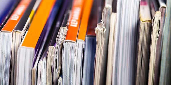 Photograph of research journals stacked side by side