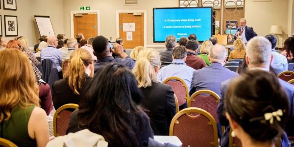 David Loseby presenting in front of delegates