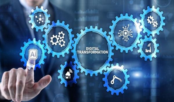 The image shows cogs centred around the words 'Digital Transformation' at the fore, with a man's finger touching the metaphorical screen on the 'AI' cog.