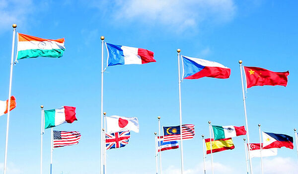 Lots of flags of different colours against a bright blue sky