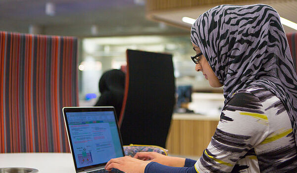 PGR student working at a laptop