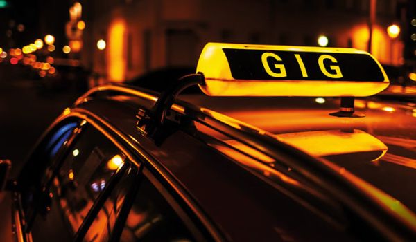 Photograph of a taxi sign atop a car, with the word 'Gig' instead of 'Taxi' being displayed