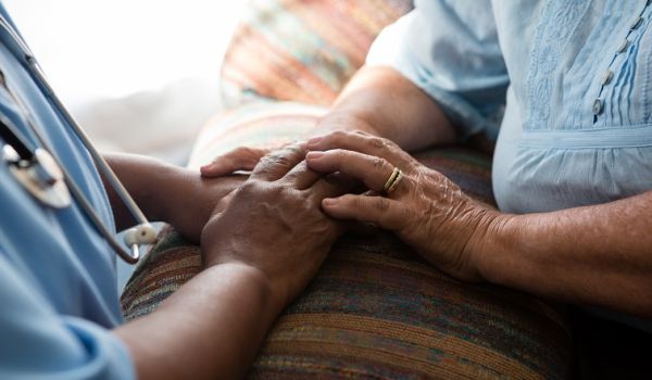 Nurse holding patient's hands