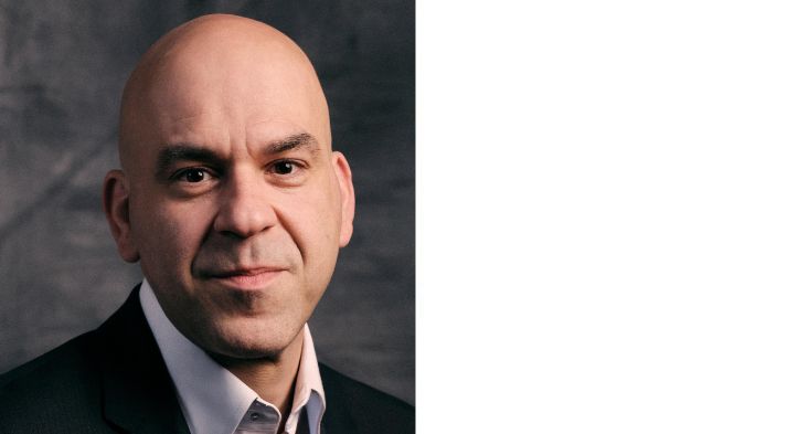 Headshot of man wearing a suit.