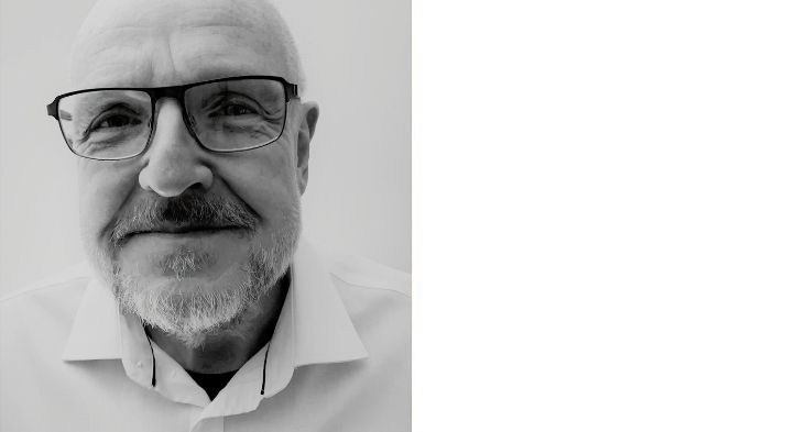 Black and white image of James Roberts looking into camera