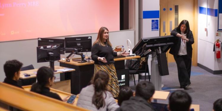 Lynn Perry delivering a talk to students