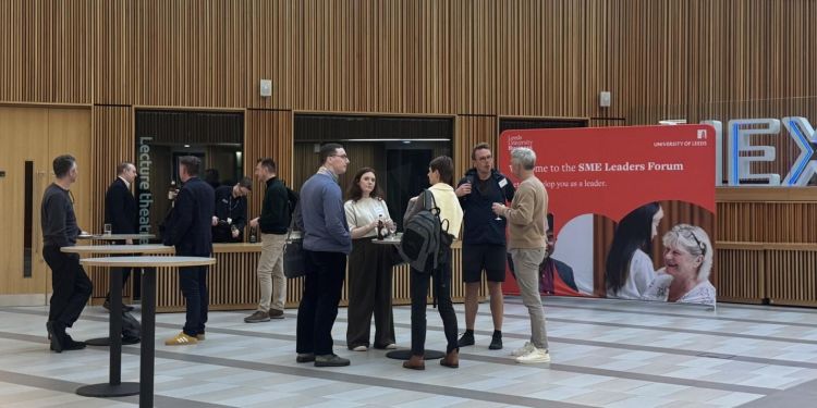 Group of event delegates standing and talking to one another.