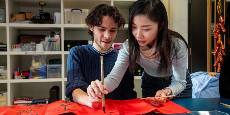 Students participate in a workshop on traditional Chinese calligraphy.