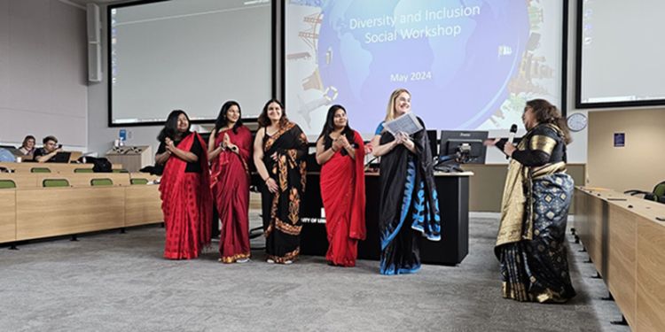 Five students stand with Dr Meenakshi Sarkar, they are wearing sarees