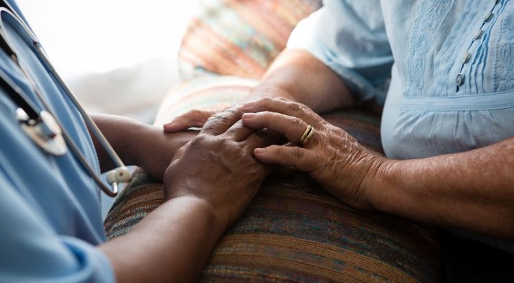 Nurse holding patient's hands