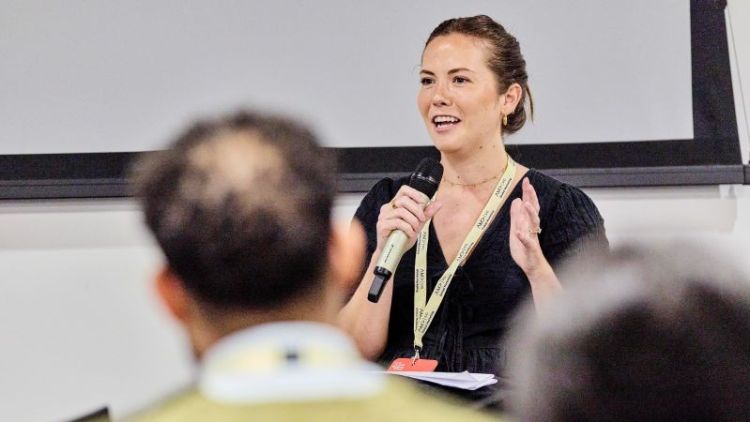 Abbie Winto speaking into a microphone
