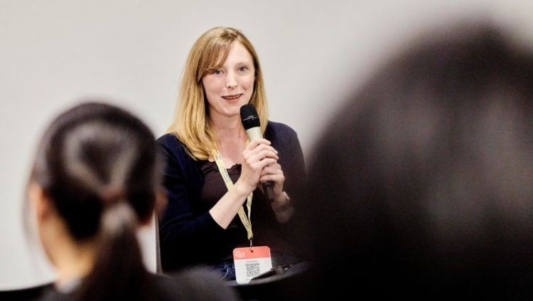 Sonja Perkovic speaking into a microphone