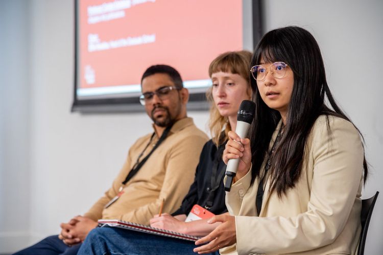 Miguel Dindia, Alexandra Seehaus and Zhuo Wang seated together, as part of a panel session