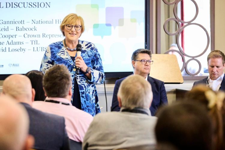 Shirley Cooper speaking into a microphone as part of a panel line up