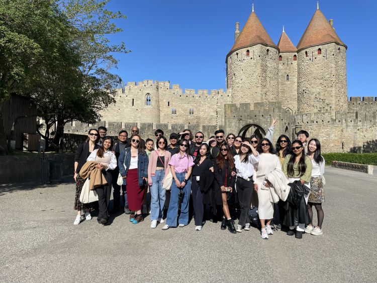 Masters students outside castle