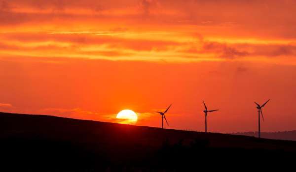 Amber sunset with a wind turbine in the background