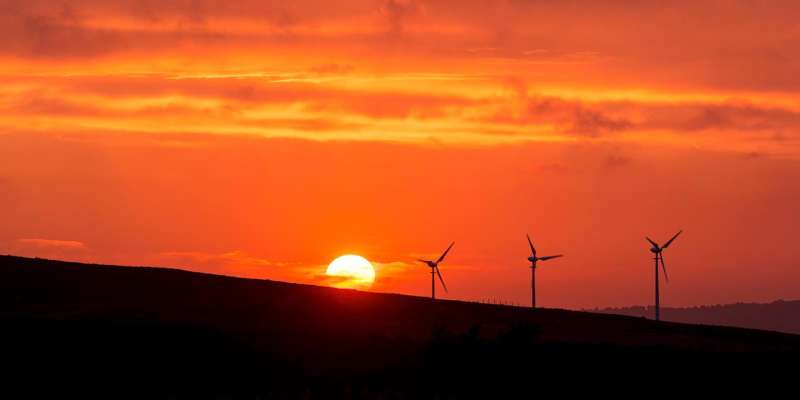 Amber sunset with a wind turbine in the background