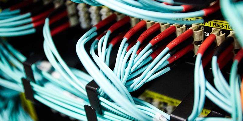 A close-up of blue wires in the University server room