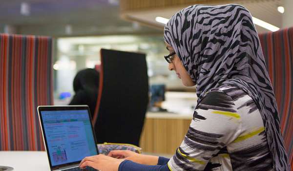 PGR student working at a laptop