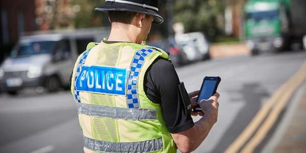 Police officer using mobile technology