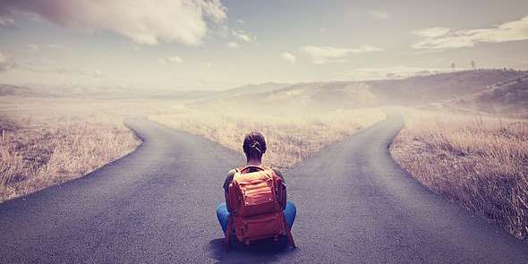 Woman sitting at a crossroads