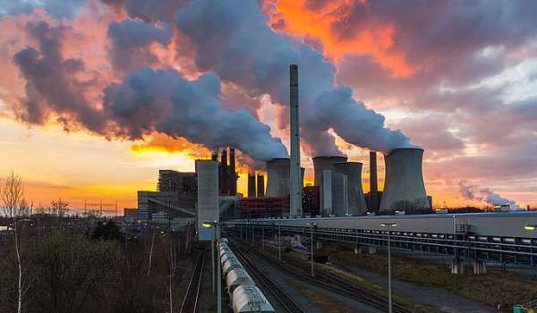 Image of a factory with smoking chimneys