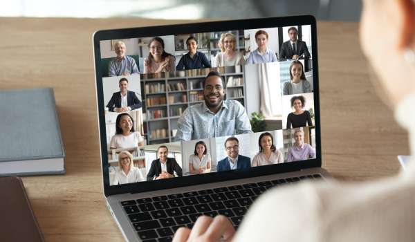 Laptop showing numerous people on a video call.