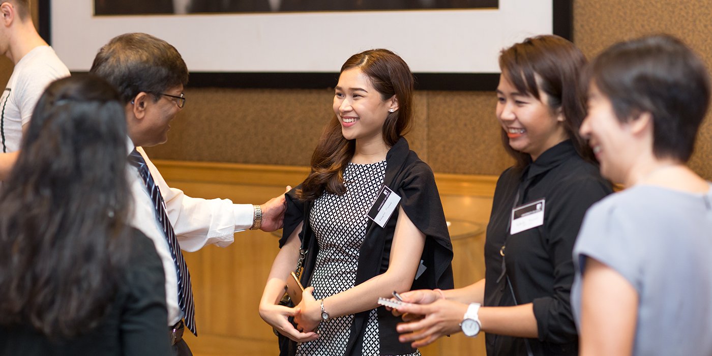Alumni and prospective students networking at an overseas event