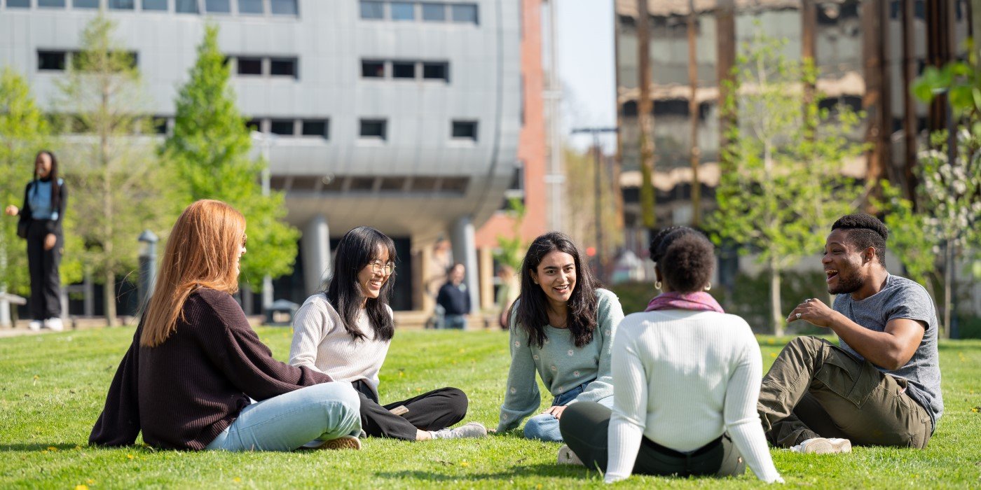 A group of undergraduate students sat outside the Charles Thackrah Building on western campus chatting.