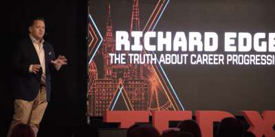 Richard Edge presenting on stage