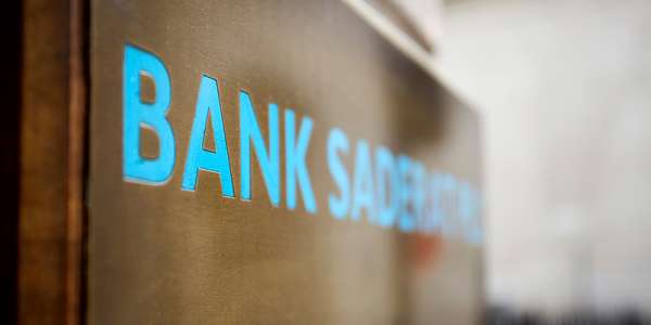 A close up of blue signage saying the word 'BANK'