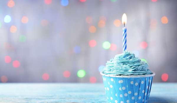 Image of a cupcake with a birthday candle stuck into it